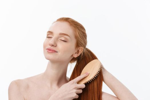 beautiful women combing hair with wooden comb isolate over white background