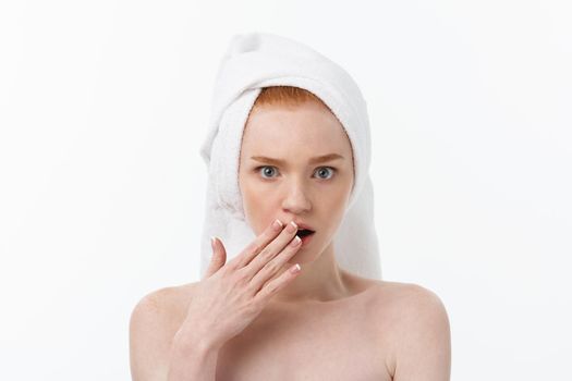 Surprised Beautiful Young Woman After Bath with A Towel On Her Head Isolated On white Background. Skin Care And Spa Theme