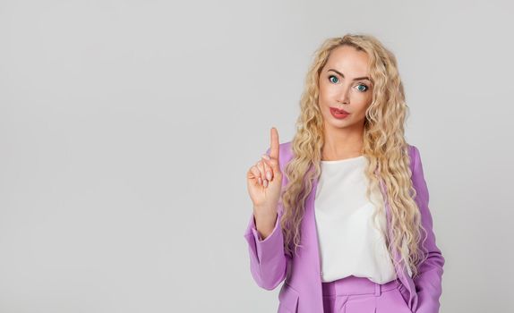 Smiling confident and happy woman blonde, saying no or prohibiting action, disapproval of shaking a finger, does not like a plan, gives a warning, scolds for a bad choice