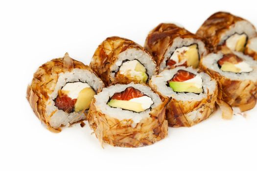 Sushi roll Bonito with smoked salmon on a white background, ingredients smoked salmon, cream cheese, avocado, tuna chips, rice, nori. Traditional Japanese food. For the restaurant menu