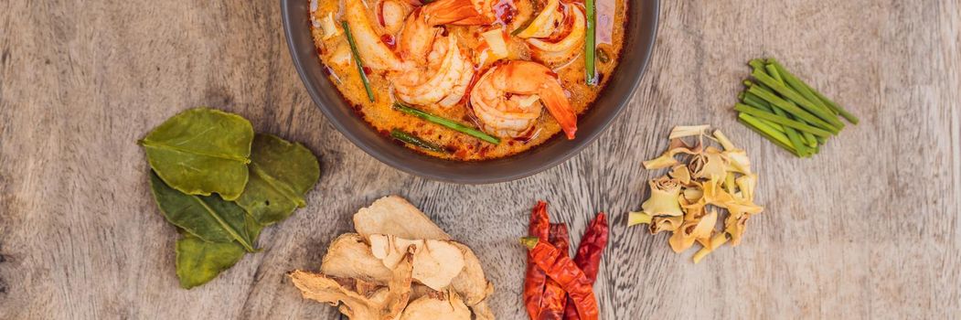 Prawn and lemon grass soup with mushrooms,Tom Yam Kung ,thai food in wooden background, top view. BANNER, LONG FORMAT