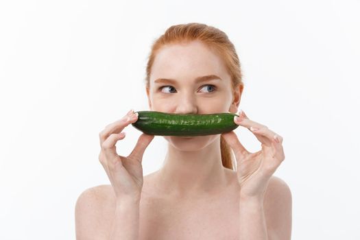 Cheerful happy beautiful girl with cucumber on her hand - isolated on white.