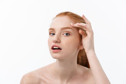 redheaded woman shows fingers on acne on her face