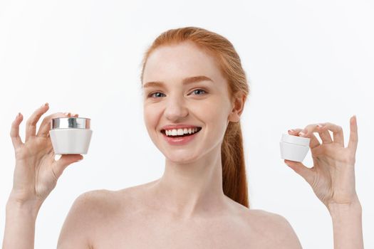 portrait of beautiful woman smiling while taking some facial cream isolated on white background with copy space