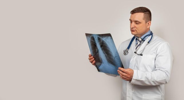 A male doctor looks and studies an x-ray of the chest. A snapshot of a person s lungs with signs of pneumonia. A genetic snapshot of small cell lung cancer