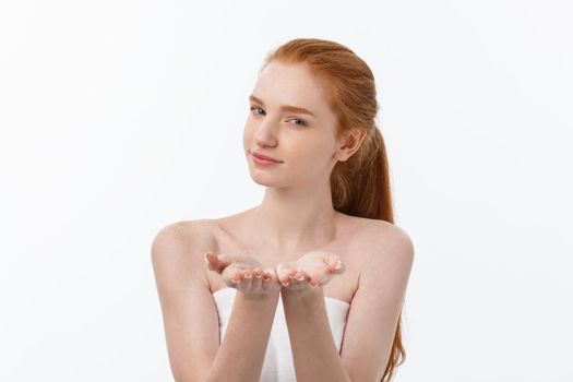 Skin care beauty woman showing empty palm with copy space for product. Excited smiling Caucasian female beauty model isolated on white background