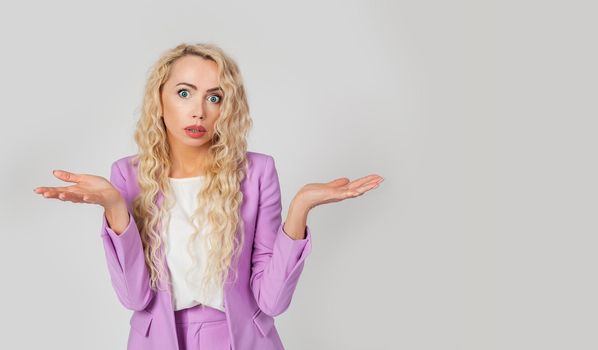 What's wrong. The embarrassed and intense woman shrugged, spread her arms. Shocked bewildered woman blonde colleague shrugging shoulders complete disbelief asks a question doubts puzzled situation
