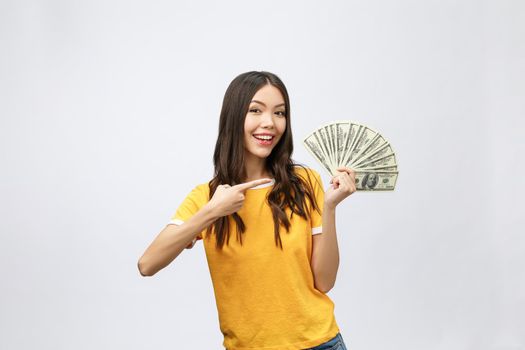 Closeup portrait of beautiful asian woman holding money isolated on white background. Asian girl counting her salary dollar note. Success wealth financial business cashflow currency payment concept.