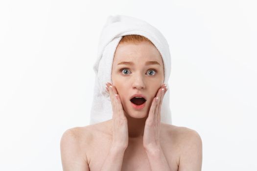 Surprised Beautiful Young Woman After Bath with A Towel On Her Head Isolated On white Background. Skin Care And Spa Theme