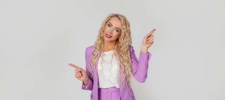 Pretty blonde woman smiles, gives advice, pointing sideways left and right, showing a good choice, promotes two products, both ways, standing on a white background