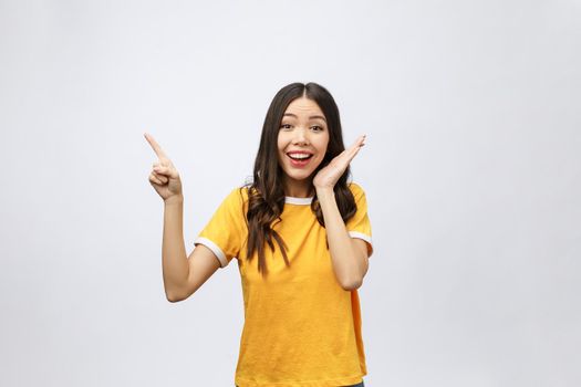 Portrait of happy young asian woman with finger point up.