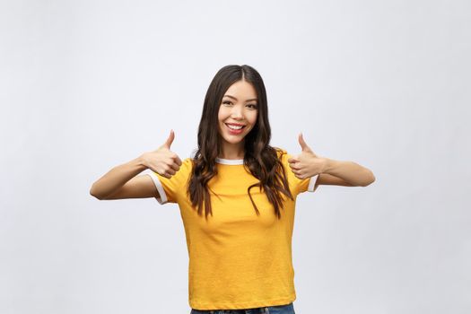 Beautiful Attractive Asian woman smile and showing thumbs up for good hand sign feeling so happiness and confident,Isolated on white background,Beauty concept