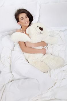 Sleeping girl with a teddy bear