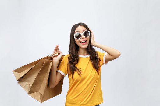 Beautiful Attractive Asian Woman smile and holding shopping bags feeling so happiness and enjoy with black Friday sale in Shopping mall,isolated on white background,Shopping Concept