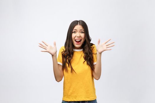 Portrait of nice shocked positive cute young girl in casual yellow shirt, opened mouth, isolated over white background.