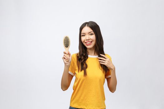 portrait of a beautiful young woman comb wonderful hair isolated on white background, asian beauty