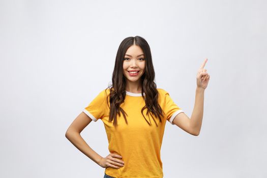 Portrait of happy young asian woman with finger point up.