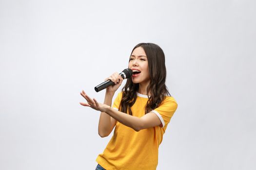 beautiful stylish woman singing karaoke isolated over white background