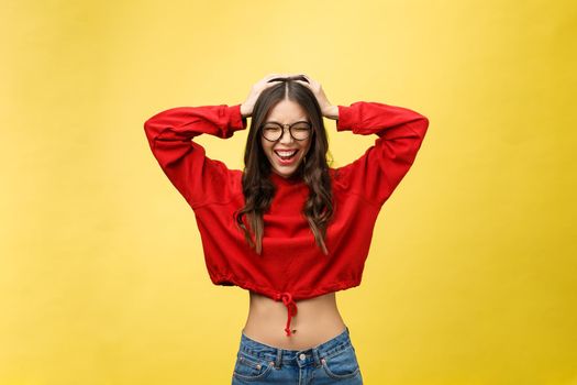 Portrait Happy Asian girl is surprised she is excited.Yellow background studio.