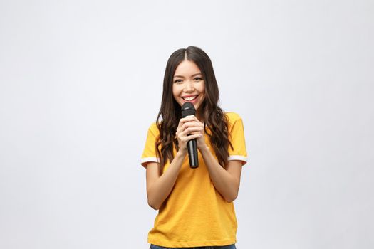 beautiful stylish woman singing karaoke isolated over white background