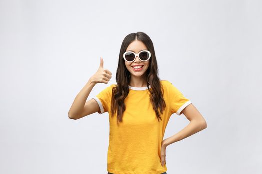 A portrait of a beautiful and cute young lady posing over white background. Fashion concept