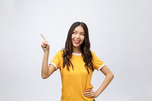 Portrait of happy young asian woman with finger point up.