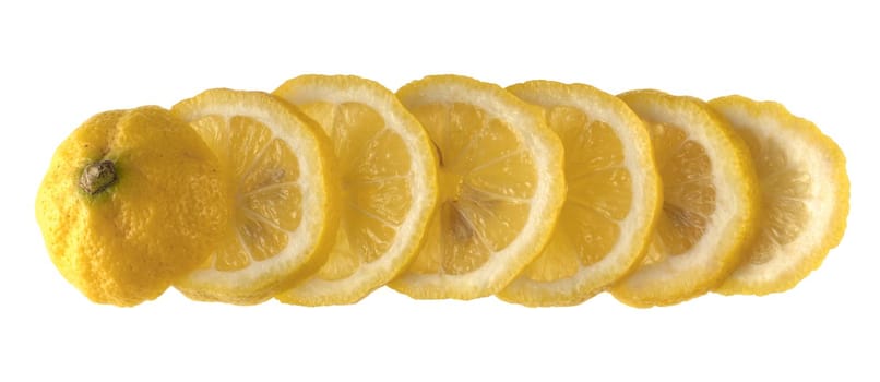 Lemon sliced in wedges and laid out in a row on a white background