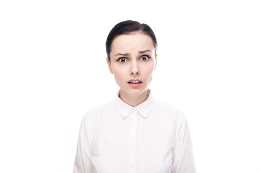 displeased woman in white shirt on white background. High quality photo