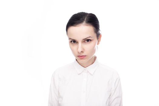 serious woman in white shirt on white background. High quality photo