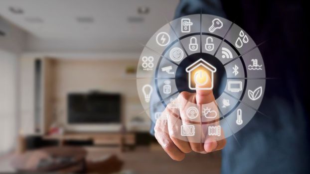 Man hand point smarth home GUI in livingroom. Hand use smart screen smart home automation assistant on a virtual screen and a user touching a button