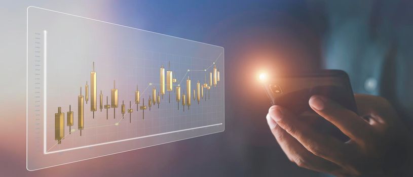 Businessman hand holds mobilephone with stock market chart. Business man analysis screen chart with mobile phone. business stock market  concept