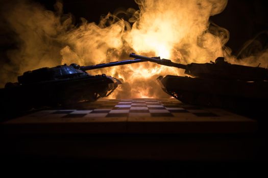 War between Russia and Ukraine, conceptual image of war using chess board and tank on a dark background of explosion. Ukrainian and Russian crisis, political conflict. Selective focus