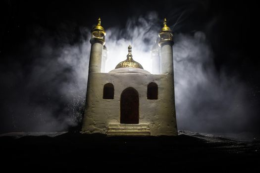 A realistic Mosque miniature with windows at night. Festive greeting card, invitation for Muslim holy month Ramadan Kareem. Selective focus