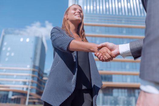 young woman shaking hands with her business partner. photo with copy space