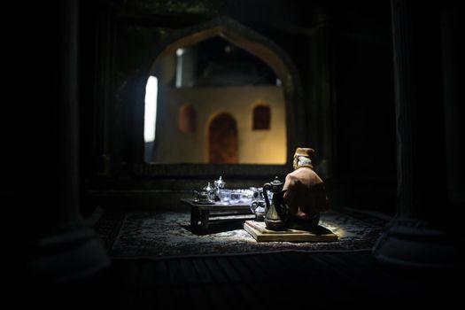 A realistic Arabian interior miniature with window and columns. Meals are served before sunrise called Suhur. Festive greeting card, invitation for Muslim holy month Ramadan Kareem. Selective focus