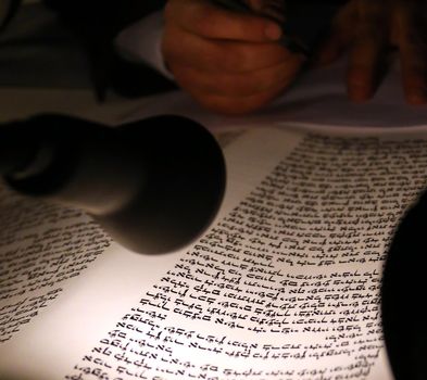 Boy reading Torahjudaism.Torah. A sacred roll which is written in manual