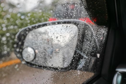 Raindrops on windshield from inside the car in traffic jam