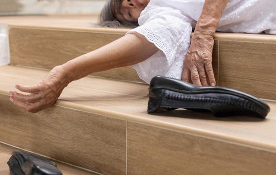 Elderly woman falling down on stair