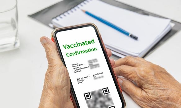 Digital Covid vaccination certificate for senior on moble phone.
