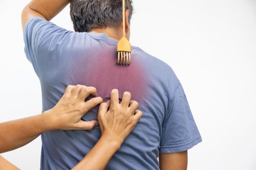 Senior man and his wife scratching his back