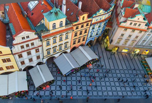 Top view of Prague Old Town Stare Mesto historical city centre. Row of buildings with colorful facades and red tiled roofs on Old Town Square Staromestske namesti in evening, Bohemia, Czech Republic