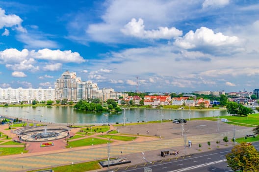 Aerial panoramic view of Minsk city historical centre with Svislach or Svislac river embankment and Traeckaje Suburb Trinity Hill, blue sky white clouds in sunny summer day, Republic of Belarus