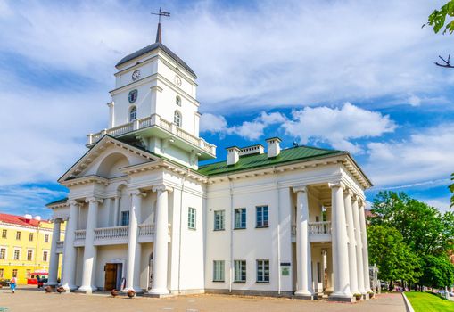 Town Hall building on Freedom Svabody square in Upper Town Minsk historical city centre, blue sky white clouds in sunny summer day, Republic of Belarus