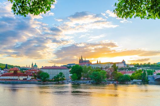 Prague historical city center. Prague Castle, St. Vitus Cathedral in Hradcany district, Mala Strana Lesser Town, Vltava river, blue sky white clouds in evening sunset view, Bohemia, Czech Republic