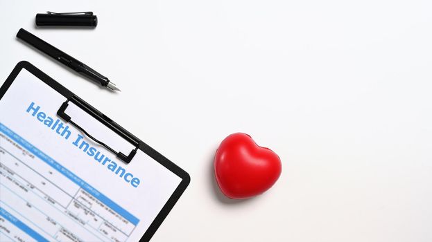 Flat lay medical report and heart on white background. Cardiology, healthcare and medical concept.