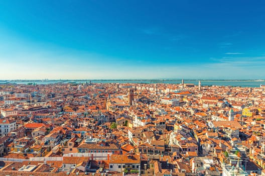 Aerial panoramic view of Venice city old historical centre, buildings with red tiled roofs, San Giuliano Mestre and blue sky background, Veneto Region, Northern Italy. Amazing Venice cityscape.