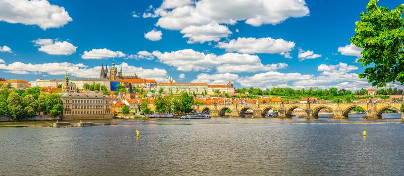 Panorama of Prague city historical centre with Prague Castle, St. Vitus Cathedral in Hradcany district, Charles Bridge Karluv Most across Vltava river. Panoramic view of Prague city, Czech Republic