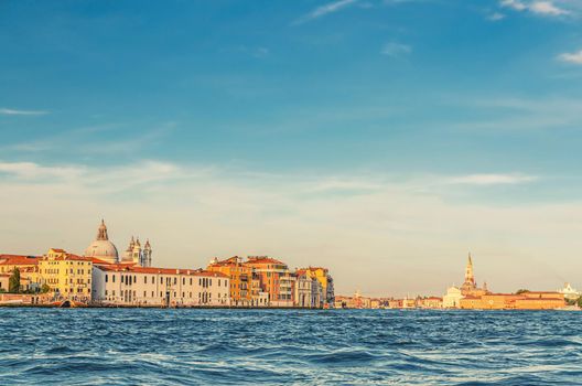 Venice cityscape with water of Giudecca canal of Venetian lagoon, embankment of Fondamenta Zattere Ai Gesuati and San Giorgio Maggiore island with catholic church and campanile bell tower, Italy