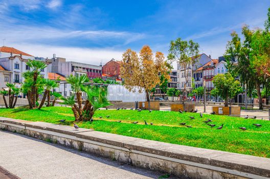 Fountain in small park and typical colorful buildings houses on Praca Conde Agrolongo square in Braga city historical centre, Norte or Northern Portugal