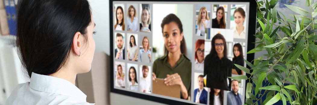 A woman looks at the display screen at a photo of people, close-up. Recruiter selects employees for the company, recruiting agency